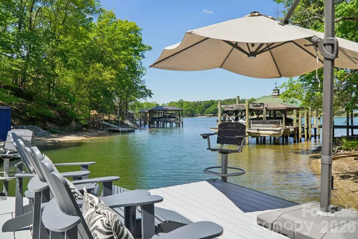 Dock with seating, 2 fishing chairs, and a large umbrella