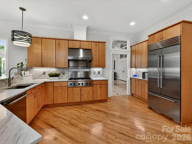 Stunning kitchen with newer quartz countertops and Subzero refrigerator