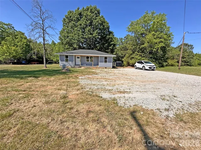 Front with gravel driveway