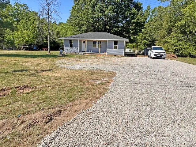 Front with gravel driveway