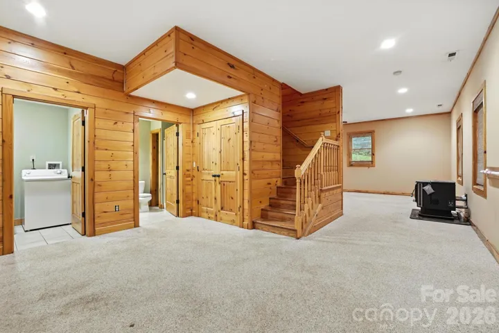 Open lower-level layout with easy access to multiple rooms, offering versatility for guests or hobbies.
