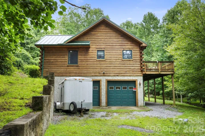 Lower-level, two car garage with additional storage space and a spacious driveway, providing convenience and functionality.