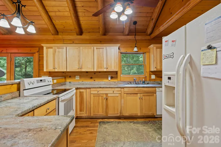 Spacious kitchen offering generous counter space and storage, complemented by warm wood finishes throughout.