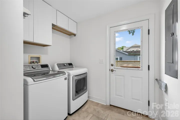 Laundry with second entrance to fenced back yard