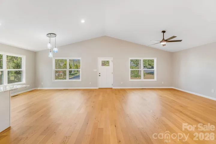 beautiful living and dining space with custom pendants