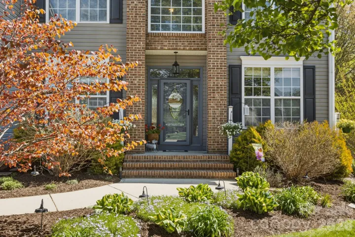 Front entry surrounded by beautiful flowers