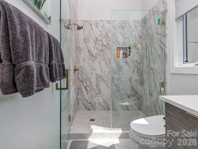 Primary Bath with Floating Dual Quartz Vanity, Tile Flooring, & Custom Walk-in Shower