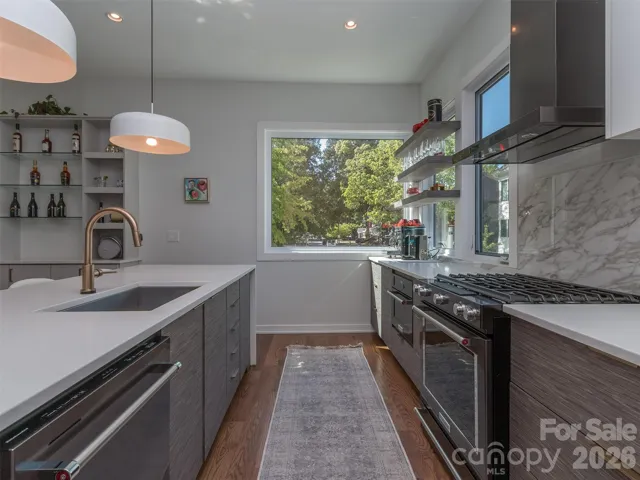 The Gourmet Kitchen is to Die For.  The Island is Quartz with Designer Waterfall Edges.  The Kitchen Also Features Gas Range, Sleek Vent Hood, Pendant Lighting, Quartz Backsplash, Floating Shelves, & The Best View of Chantilly's Tree Lined Neighborhood Street!