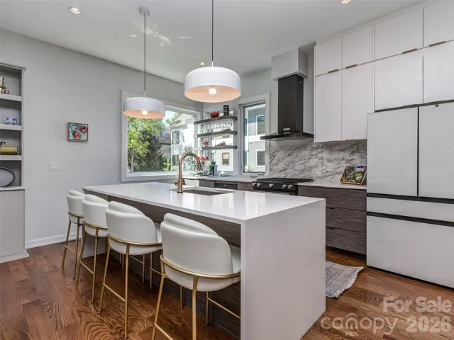 The Gourmet Kitchen is to Die For.  The Island is Quartz with Designer Waterfall Edges.  The Kitchen Also Features Gas Range, Sleek Vent Hood, Pendant Lighting, Quartz Backsplash, Floating Shelves, & The Best View of Chantilly's Tree Lined Neighborhood Street!