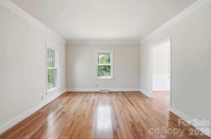 Flex Room with hardwood floors, windows and molding. 
