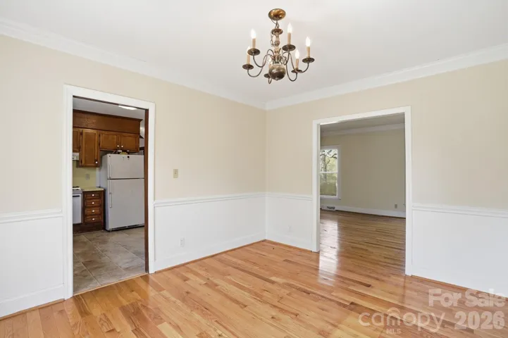 Dining room with molding and hardwood floors.  