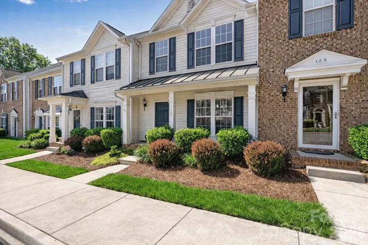 Welcome to 122 Kallie Loop - enjoy covered front porch and assigned parking spaces. Grass virtually enhanced.
