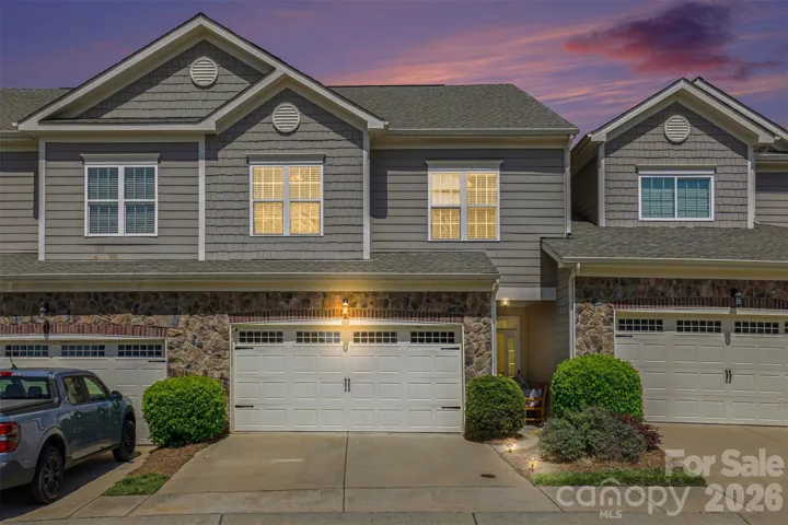 Stone and brick add warm curb appeal to the two car gagage
