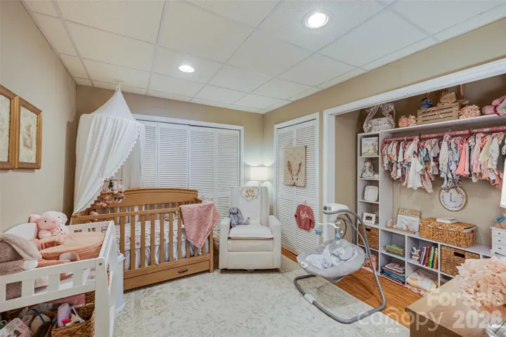 Laundry room in second living quarters currently being used as nursery.  Laundry hook up behind shelves.