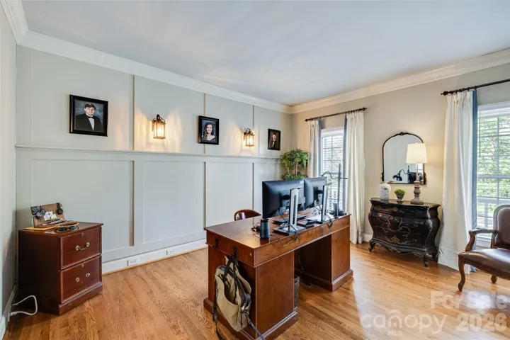 Home office with custom woodwork and french doors to the living room.