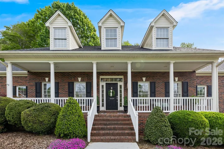 Rocking chair front porch & full brick home.