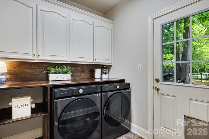 Laundry room on main is spacious with extra storage and dog door to dog run.