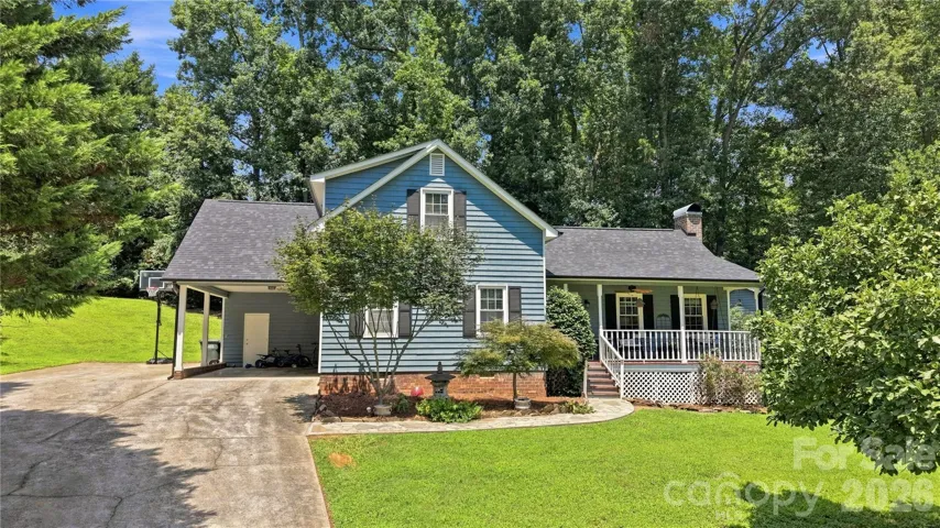 Beautiful curb appeal, one car carport, rocking chair covered front porch.