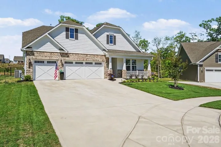 Expansive driveway offers additional parking beyond the three-car garage.
