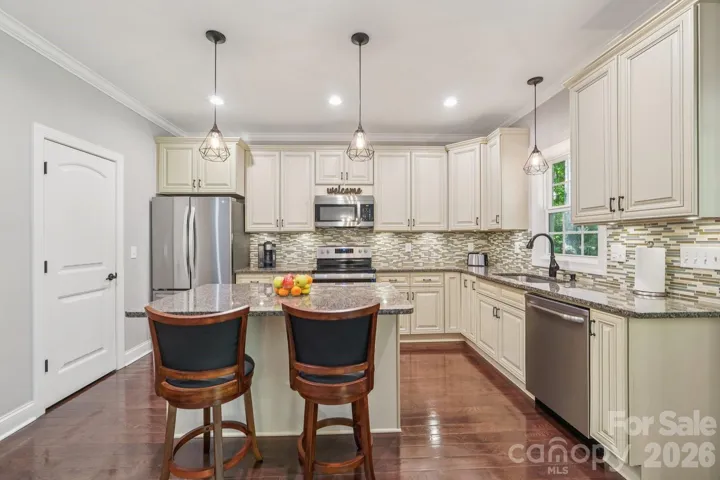 Kitchen has cream cabinets with soft close hinges