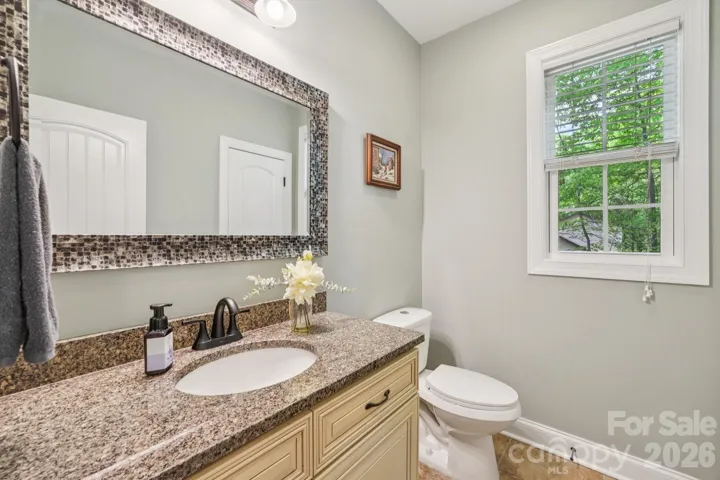 Main floor half bath has large linen closet