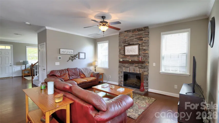 Spacious great room open to dining and kitchen with stone fireplace