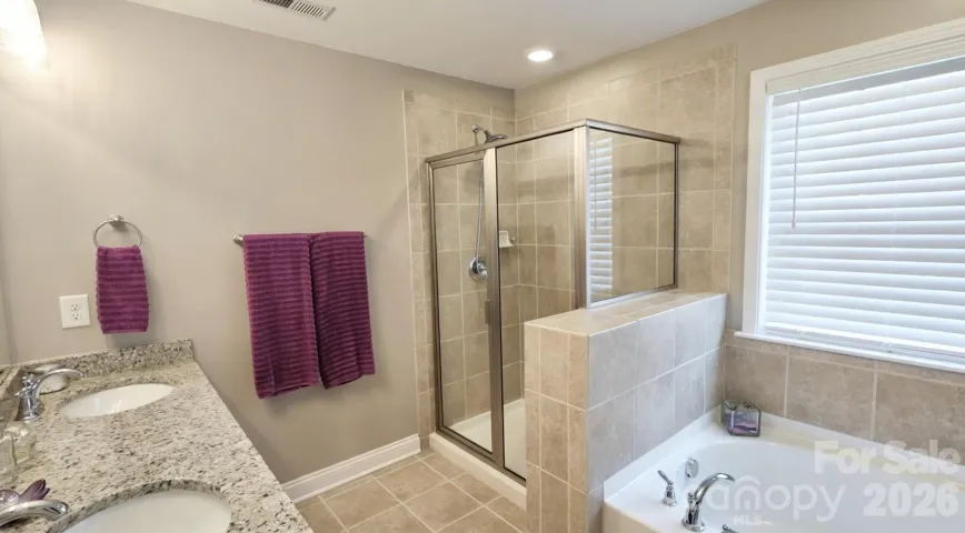 Primary bedroom with ensuite bathroom and walk in closet