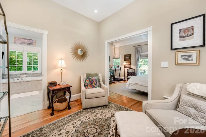 There is a spacious sitting room as you enter the primary suite on the main floor.