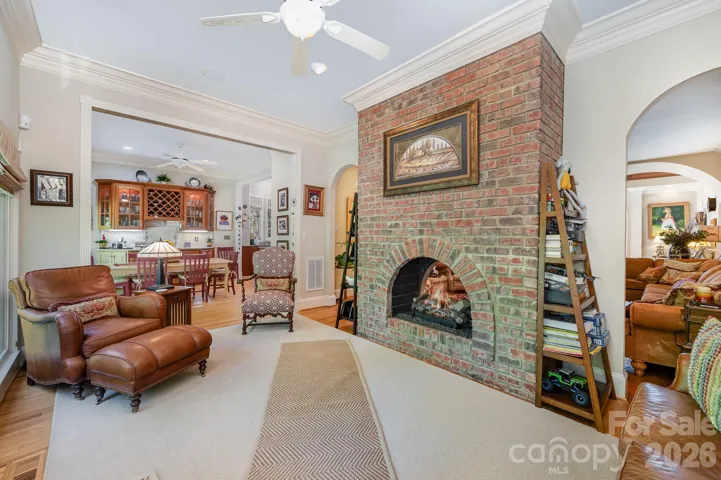 The bright sunroom has a peep-through fireplace into the family room.