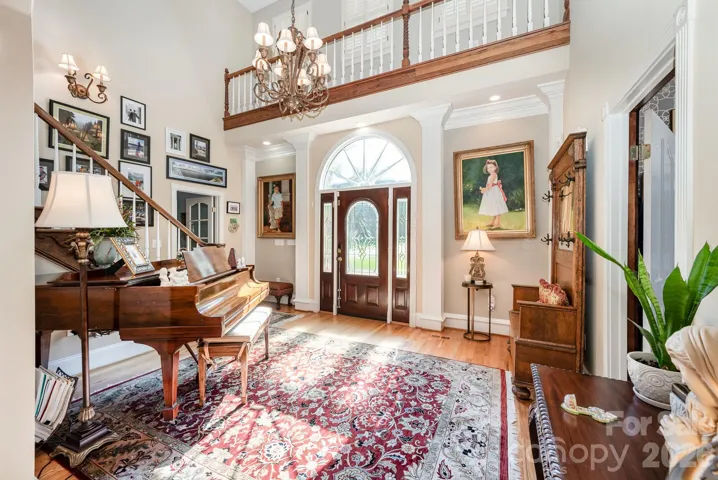 Soaring ceilings and an open foyer welcome you upon entry. PLEASE NOTE: Interior furnishings are different from photos in all rooms.