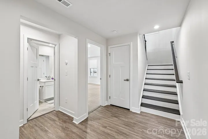 Downstairs Hall with Wide and Inviting Staircase
