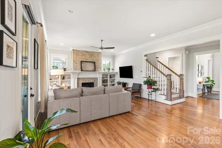 Curl up by the fire... transom windows above the built-ins make this room feel even taller.