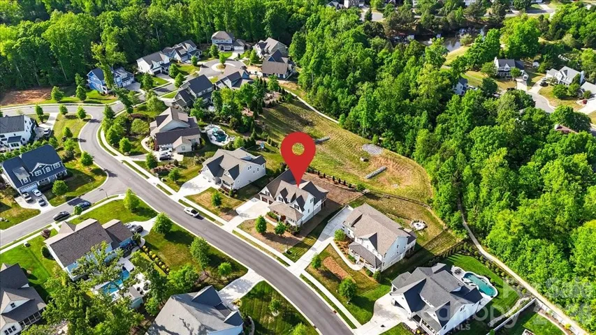 Your front-row seat to The home's setting becomes clear from above... privacy, trees, and sidewalks just outside your door