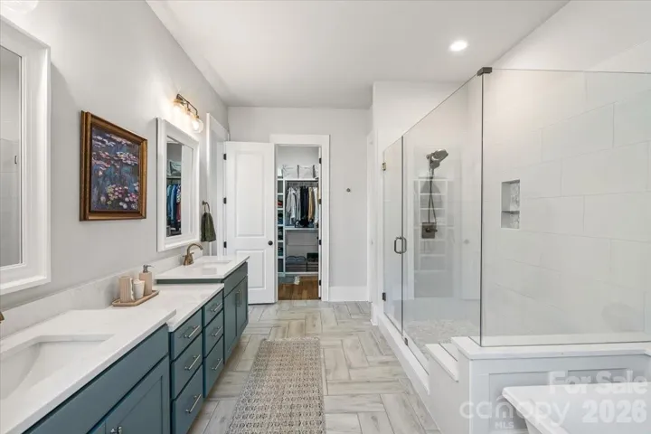 One of two oversized walk-in closets accessed in the primary bathroom... yes, two.