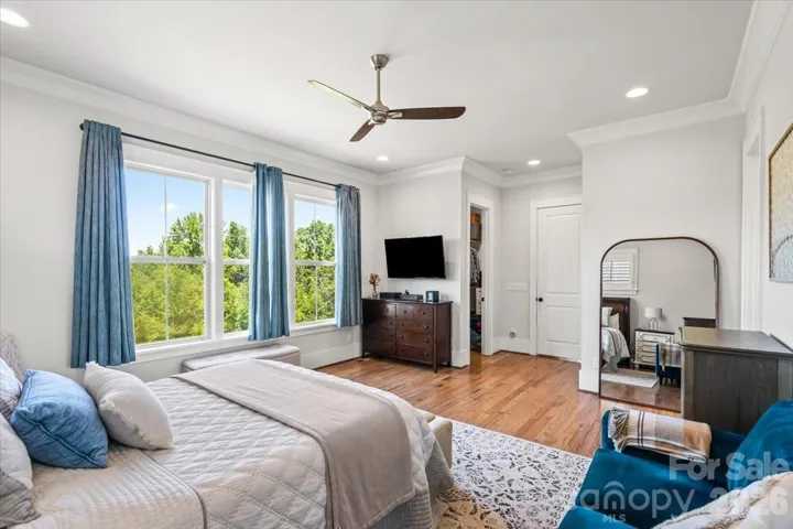 A serene palette and abundant natural light make this primary suite hard to leave