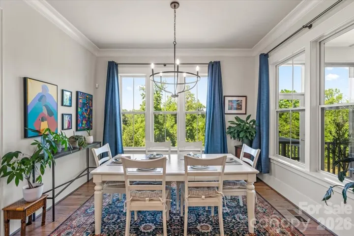 The dining area sits just off the kitchen... close enough to entertain, far enough to feel its own