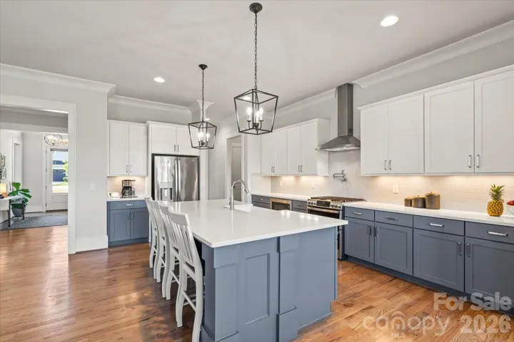 A chef's kitchen including double-oven is built for daily meals and Saturday-night gatherings.