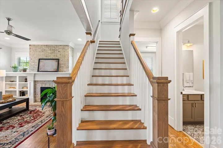 Hardwood stairs lead up to the additional bedrooms and bonus space.