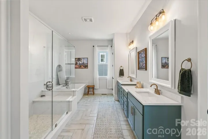 Beautifully updated 2025 en suite... dual vanities, custom tile, and finishes that feel brand new (because they are).