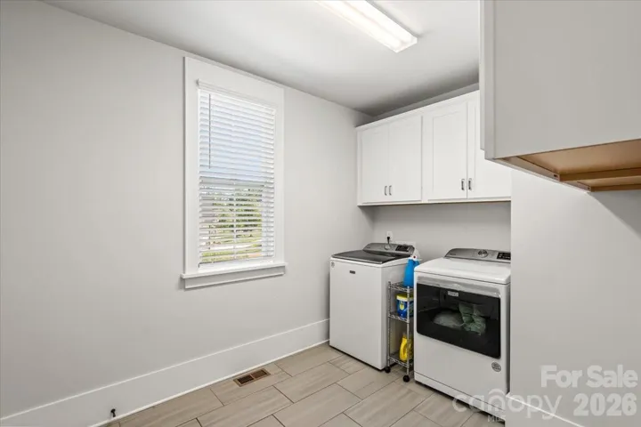 Spacious main-level laundry with built-in storage and counter space... daily life, made simpler.