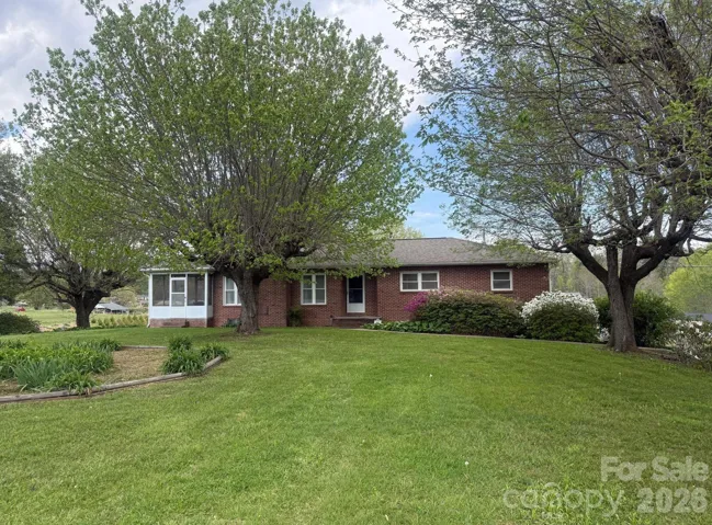 Front view of the home with the large front yard.