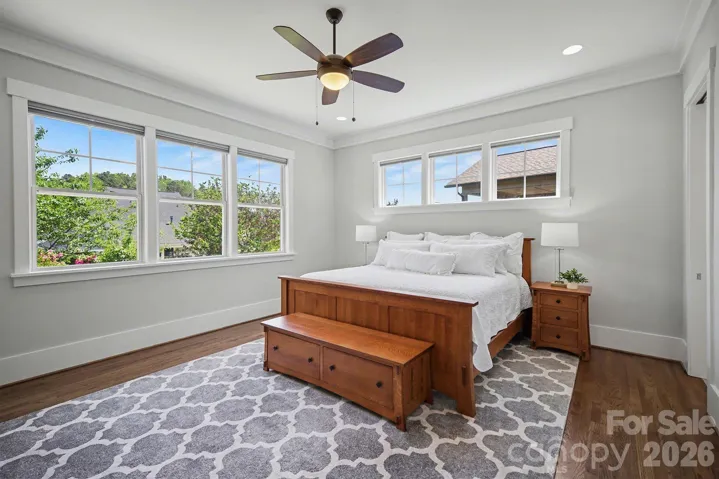 Primary suite on the main level overlooks the beautifully landscaped back yard