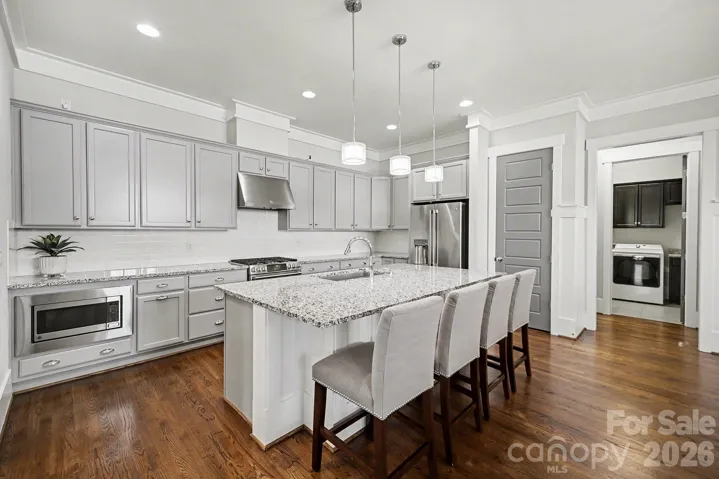 Chef's kitchen features an oversized island seats 4 and GE Cafe appliances - including an under-cabinet ice maker!
