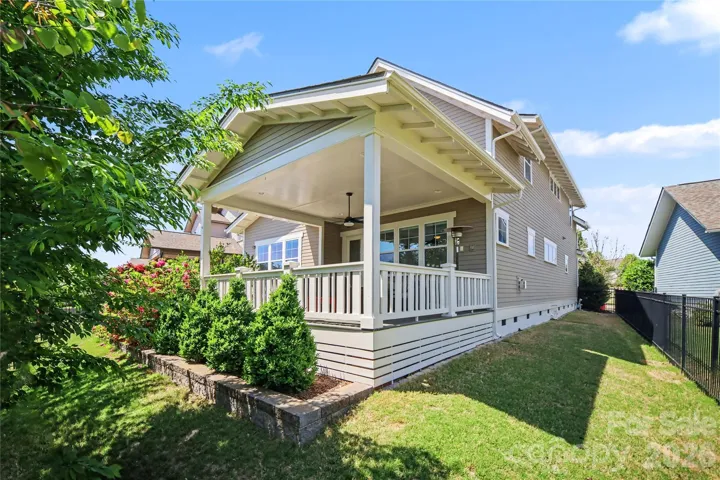 The landscaping includes a well-maintained lawn and ornamental plants and trees.