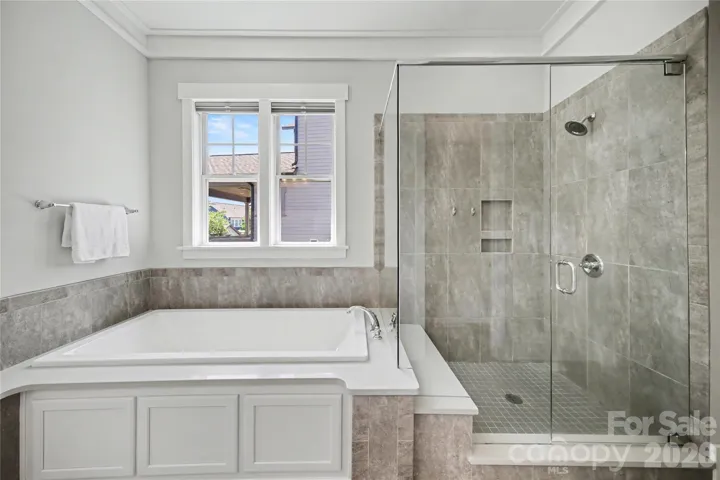 Oversized shower and soaker tub in the primary bathroom