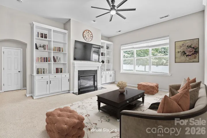 Cozy gas fireplace framed by custom built-in bookshelves.