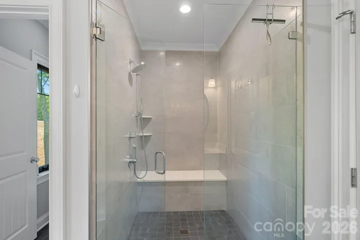 Tiled primary shower has a zero-entry access 