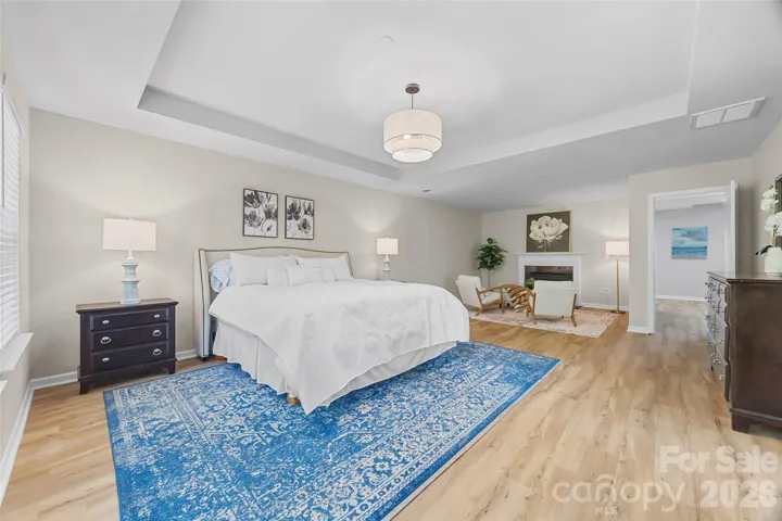 Large Primary Bedroom w/ seating area and fireplace