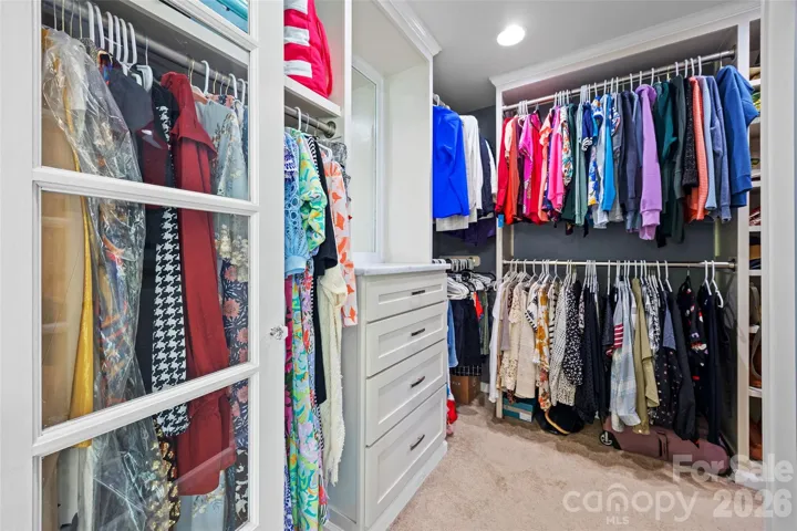 Primary closet w/ custom shelves is a beauty! 
