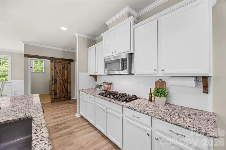 Chef's kitchen w/ SS appliances, granite countertops, double ovens, gas cooktop large island and walk in pantry